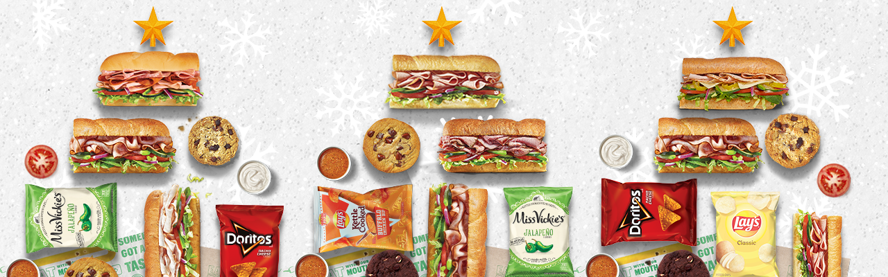 Sandwiches, cookies and bags of chip in the shape of a Christmas tree.
