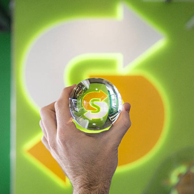 A glass sphere held over the Subway logo