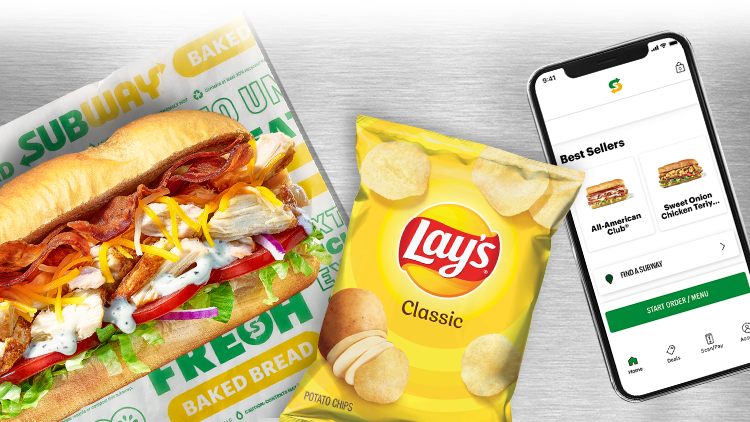 A sub, bag of chips and phone with Subway App on the screen