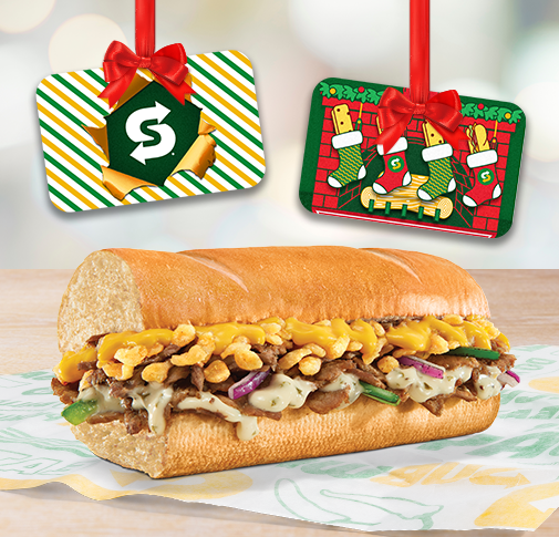 Six-inch Cheesy Garlic Steak with two Subway holiday gift cards hanging down from frame.